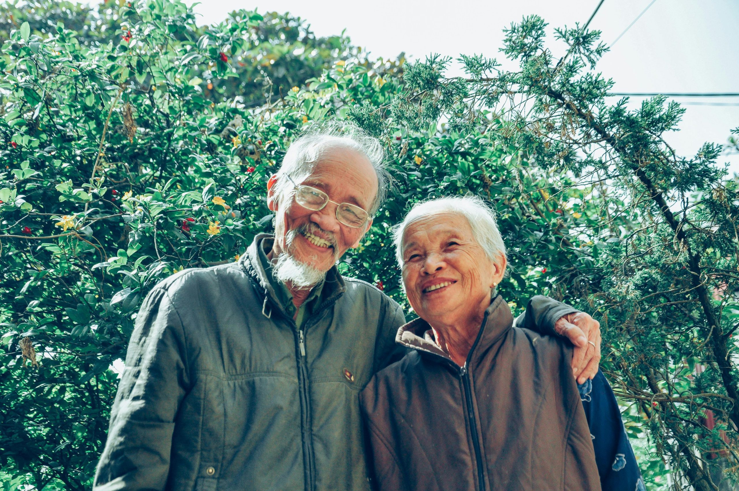 Smiling Man and Woman Wearing Jackets