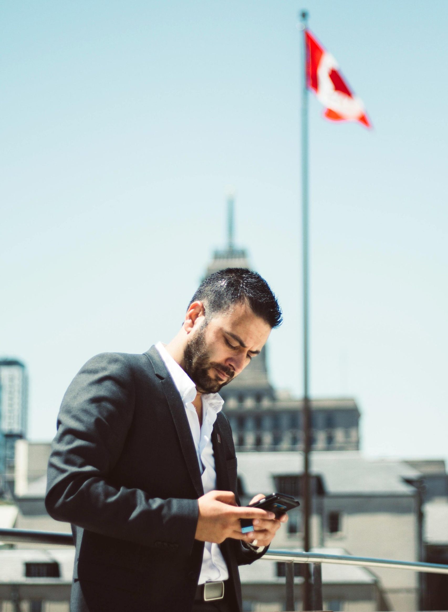 Man in Suit Jacket Holding Phone