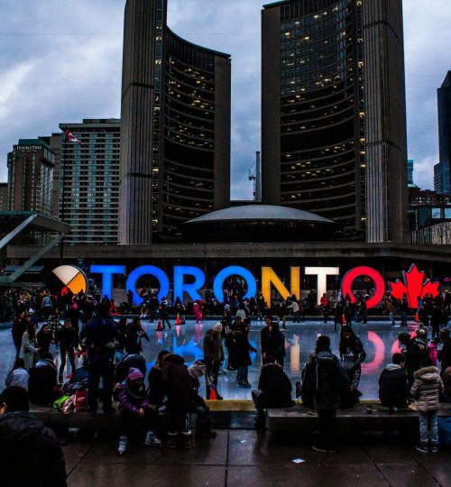 People Gathered in Front of Toronto Freestanding Signage